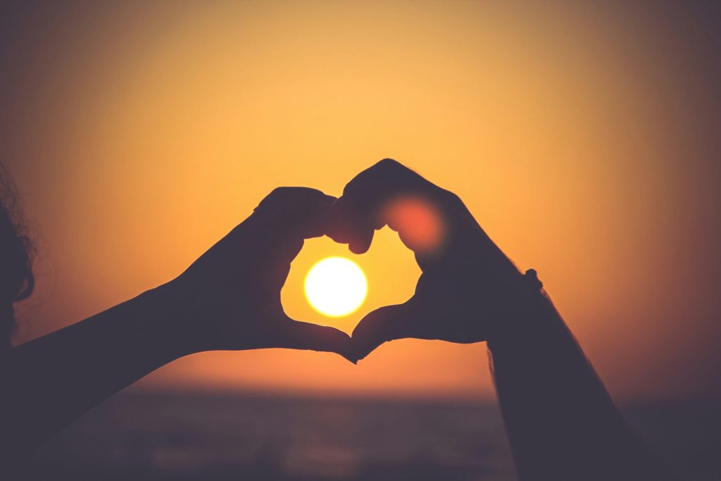 picture of couple creating a heart at sunset for Couple Pictures