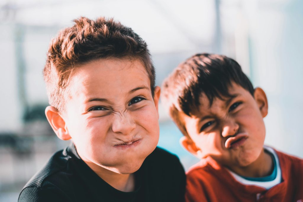 Family Portraits of two boys making a funny face