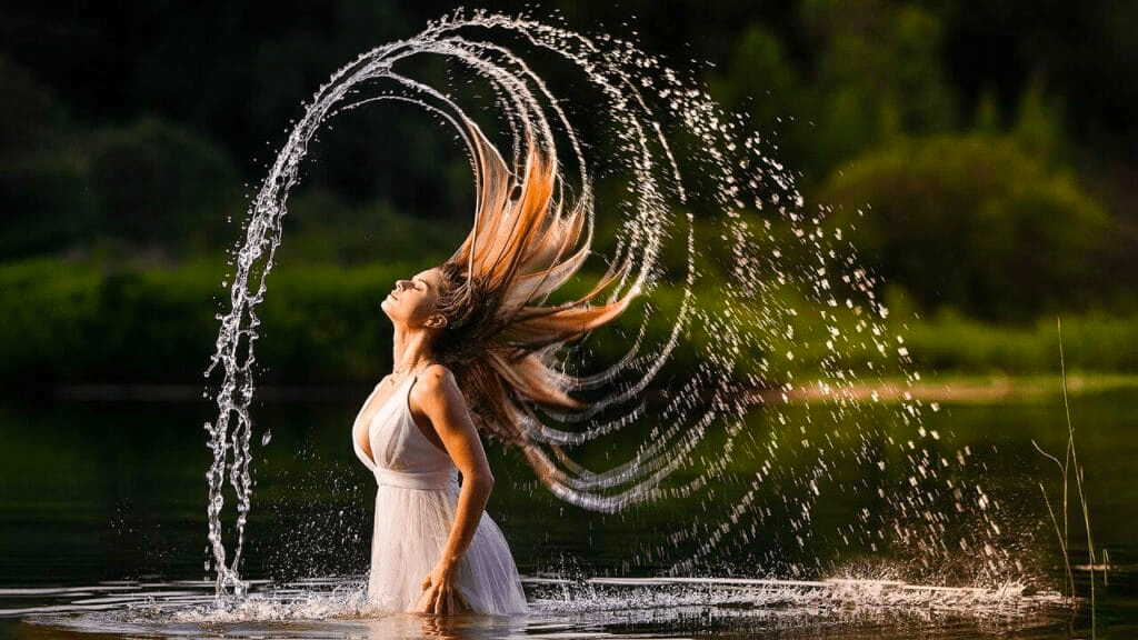 women flipping hair in water with fast shutter speed giving a darker exposure 