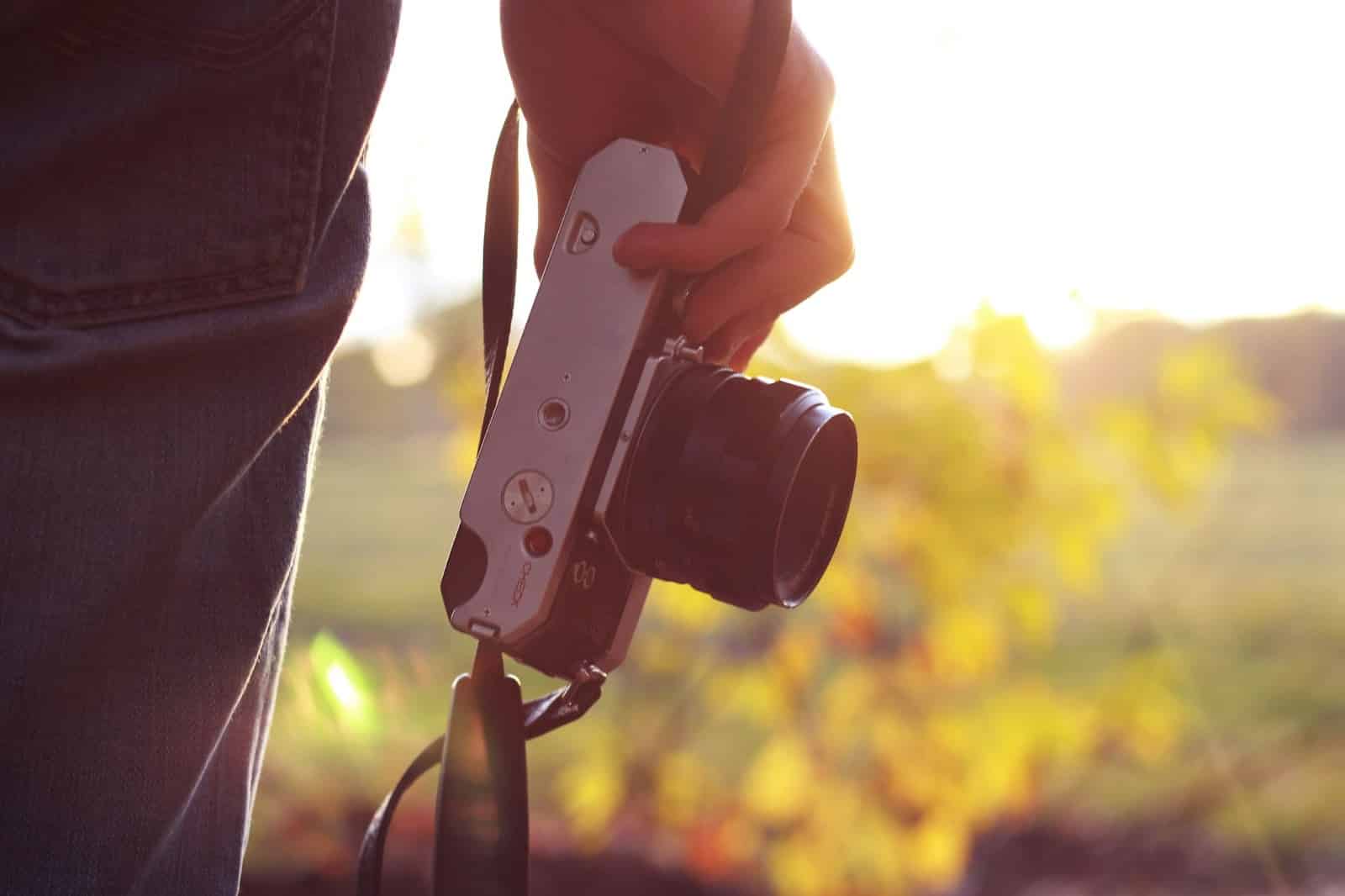 man holding camera with bright sunlight