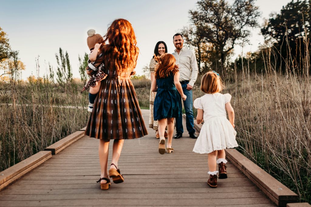 family pictures taken on a boardwalk